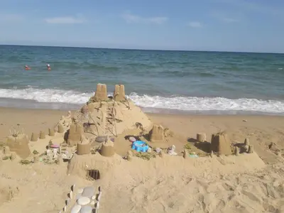 a sand castle on a beach near the ocean at Villa Byala Grape House in Byala