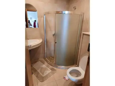 a bathroom with a shower and a toilet and a sink at Sunny Villa in Byala