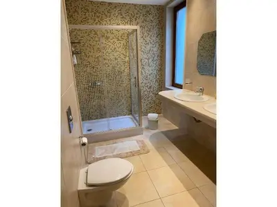 a bathroom with a toilet and a shower and a sink at Sunny Villa in Byala