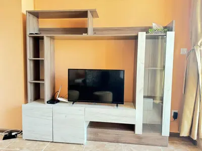 a entertainment center with a tv in a living room at Guest Apartment The Fabulous Sunset -Sozopol in Sozopol