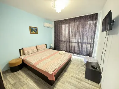 a bedroom with a bed in front of a window at Guest Apartment The Fabulous Sunset -Sozopol in Sozopol