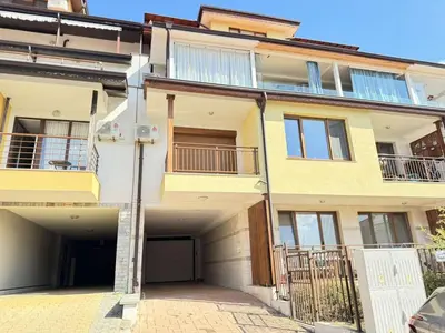 an apartment building with a garage in front of it at Guest Apartment The Fabulous Sunset -Sozopol in Sozopol