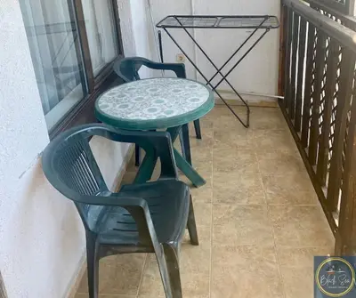 two chairs and a table on a balcony at 2 Bed Apt at Watermill Complex in Sveti Vlas