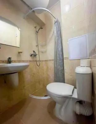 a bathroom with a toilet and a sink and a shower at Апартаменты Мисаря in Sozopol