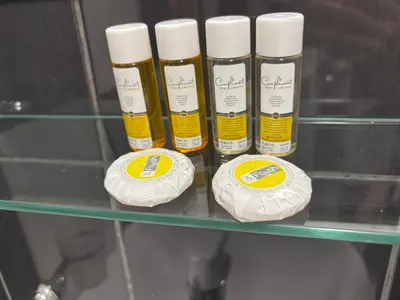 four bottles of moisturizers sitting on a glass shelf at GRAND STUDIO SEA GARDEN - top center in Burgas City