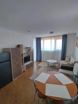 a living room with a table and a couch at Bay View Villas apartment NONA 1C - Kosharitsa in Kosharitsa