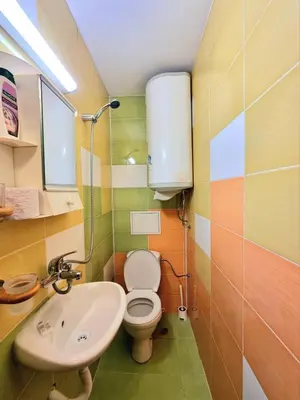 a small bathroom with a toilet and a sink at Mezonet - Sol Casa in Lazur in Burgas City
