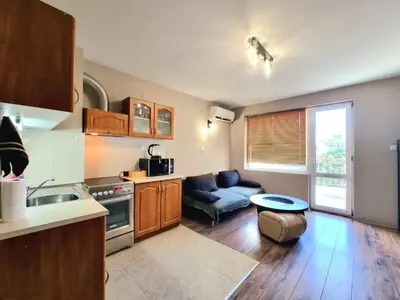 a kitchen with a couch and a table in a room at Mezonet - Sol Casa in Lazur in Burgas City
