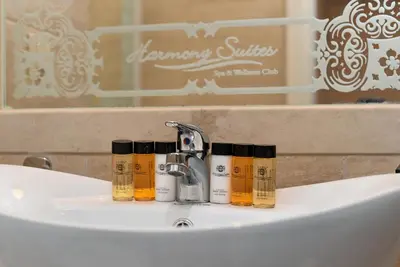 a bathroom sink with four bottles of essential oils on it at Harmony Suites - Monte Carlo in Sunny Beach
