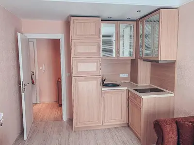 a kitchen with wooden cabinets and a sink at Urlaub in Harmony in Sunny Beach