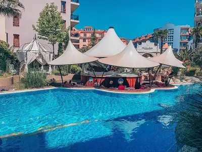 a swimming pool with a white canopy over it at Urlaub in Harmony in Sunny Beach
