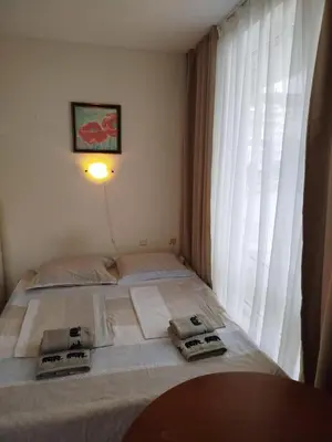 a bed in a room with a large window at Aria private apartments in Fort Noks Grand Resort - Saint Vlas in Elenite