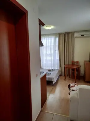 a living room with a couch and a bed in a room at Aria private apartments in Fort Noks Grand Resort - Saint Vlas in Elenite