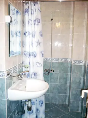 a bathroom with a sink and a shower at Hotel Bobchev in Sozopol
