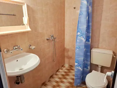 a bathroom with a sink and a toilet and a shower at Hotel Bobchev in Sozopol