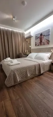 a bedroom with a large bed with two towels on it at Kate`s Place in Burgas City