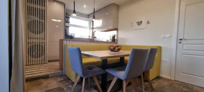 a kitchen with a table and two blue chairs at Kate`s Place in Burgas City