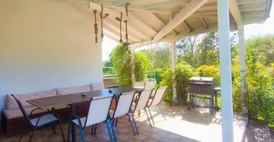 a patio with a table and chairs and a grill at Casa Alegra in Bliznatsi