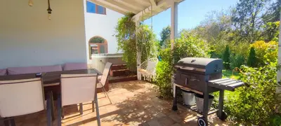 a backyard patio with a grill and a table and a grill at Casa Alegra in Bliznatsi