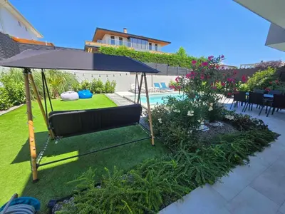a patio with an umbrella and a pool at Villa Felicity, private pool with heating and salt water in Lozenets