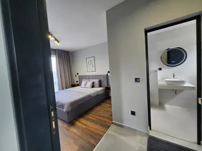 a bedroom with a bed and a sink and a mirror at Villa Felicity, private pool with heating and salt water in Lozenets