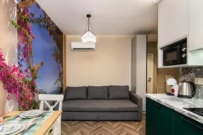 a living room with a couch in a kitchen at Tiny studio in center of Varna in Varna City
