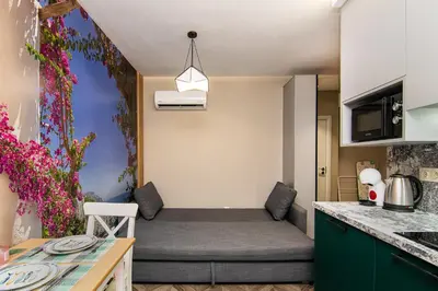 a small room with a bed in a kitchen at Tiny studio in center of Varna in Varna City