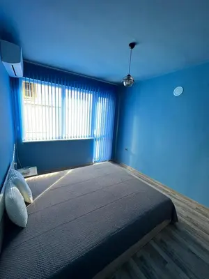 a blue room with a bed and a window at Varna Top Central Apartment-Tulip in Varna City