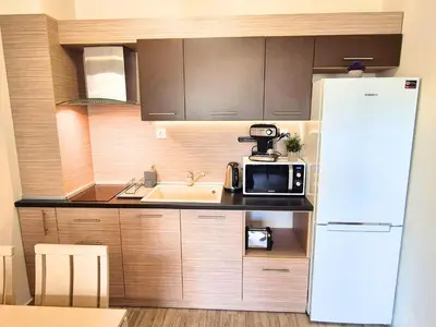 a kitchen with a sink and a white refrigerator at Attractive Apartment in Sunny Beach Cascadas Family Resort in Sunny Beach