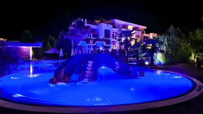 a swimming pool with a slide in front of a house at Attractive Apartment in Sunny Beach Cascadas Family Resort in Sunny Beach