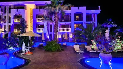 a hotel with blue lighting in front of a building at Attractive Apartment in Sunny Beach Cascadas Family Resort in Sunny Beach