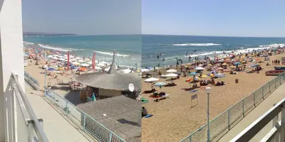 a beach with a crowd of people and the ocean at SeaInn in Obzor