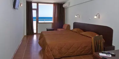 a bedroom with a bed with a view of the ocean at SeaInn in Obzor