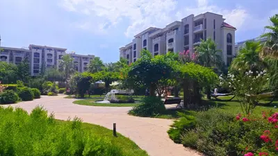 a park with tall buildings and trees and flowers at Attractive Studio-Apartment in Sunny Beach Cascadas Family Resort in Sunny Beach