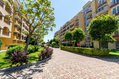 a brick sidewalk in front of apartment buildings at Midia Holiday Apartments in Aheloy