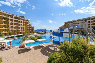 a resort with a slide and a pool at Midia Holiday Apartments in Aheloy
