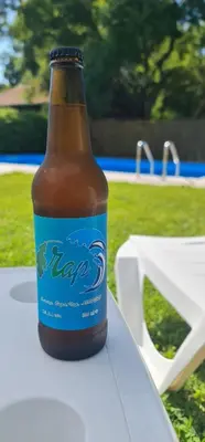 a bottle of beer sitting on top of a table at Hotel Char in Primorsko