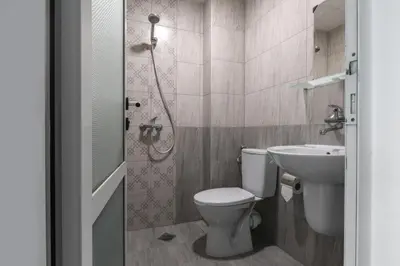a bathroom with a toilet and a sink at Hotel Char in Primorsko