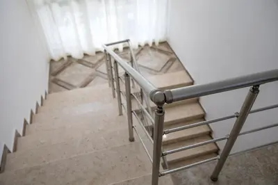 a set of stairs in a room with white curtains at Hotel Char in Primorsko