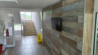 a living room with a wall made out of wood at Hotel Char in Primorsko