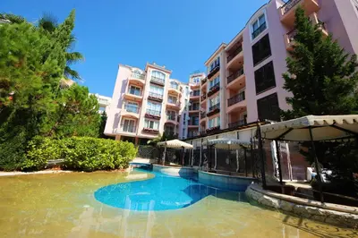 a swimming pool in front of some apartment buildings at Menada Romance Marine Apartments in Sunny Beach