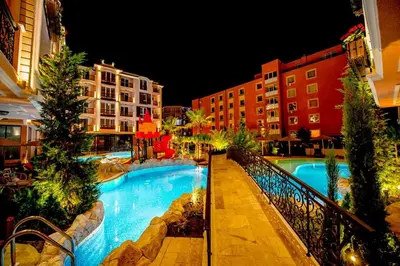 a view of a swimming pool at night at Menada Romance Marine Apartments in Sunny Beach