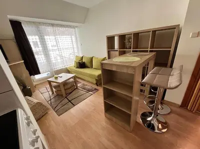 a living room with a couch and a desk in it at Cosy apartment near the beach with terrace & sea view in Burgas City