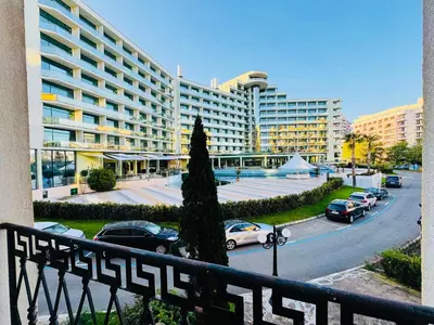 a view of a building with cars parked in a parking lot at VICTORIA RESIDENCE Two Bedroom Sunny Beach in Sunny Beach
