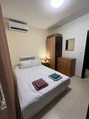 a bedroom with a bed with two towels on it at Sunset Apartment Pomorie in Pomorie