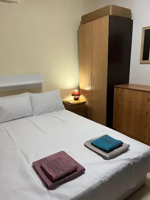 a bedroom with a white bed with towels on it at Sunset Apartment Pomorie in Pomorie