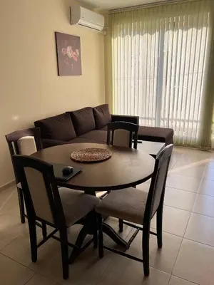 a living room with a table and a couch at Sunset Apartment Pomorie in Pomorie