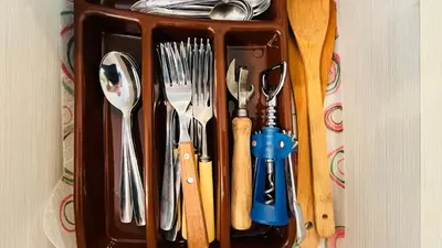 a container filled with utensils on a table at Amara В 10 Sunny Beach in Sunny Beach