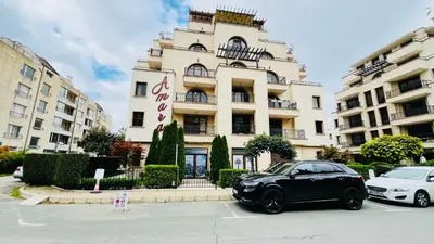 a black car parked in front of a building at Amara В 10 Sunny Beach in Sunny Beach