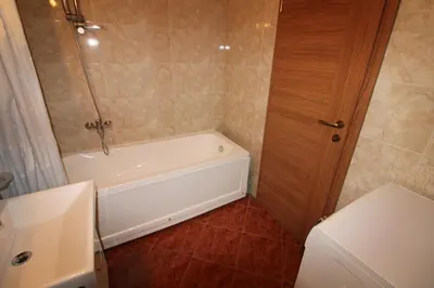 a bathroom with a bath tub and a toilet at Prestige Fort Beach - Menada Apartments in Sveti Vlas
